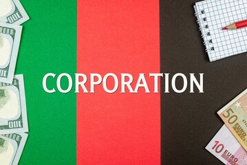CORPORATION - word (text) and money dollars and euros on a table made of different colors, a notepad and a red pencil. Business concept, buy, sell, exchange (copy space).