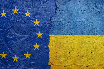 European Union and Ukraine - Cracked concrete wall painted with a Ukrainian flag on the left and a Russian flag on the right stock photo