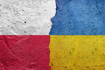Poland and Ukraine - Cracked concrete wall painted with a Polish flag on the left and a Ukrainian flag on the right stock photo