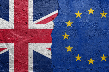 United Kingdom vs European Union - Cracked concrete wall painted with a UK flag on the left and a EU flag on the right stock photo