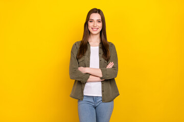 Photo of cheerful good mood intelligent business lady with folded arms posing on camera isolated on yellow color background