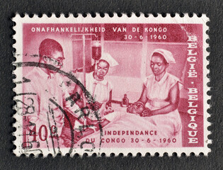 Cancelled postage stamp printed by Belgium, that shows Doctor and Nurses with Patient, Congo Independence, circa 1960.