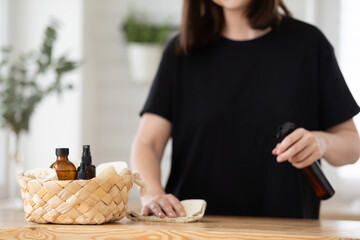 Young woman cleans the kitchen with eco products.