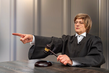 Judge banging judge's gavel, index finger pointing. Law Lord wearing gown using a hammer for attention and verdict, justice judgment at courts of law