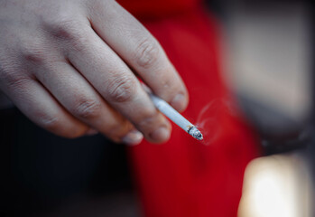 Hand with cigarette close up. Tobacco smoking. Health deseases. Toxic  addiction.