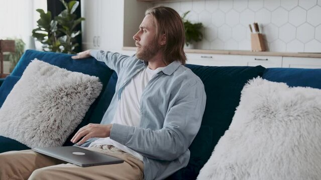 Casually dressed male entepreneur is looking sad angry and frustrated, closing his laptop dissapointed with a failure.