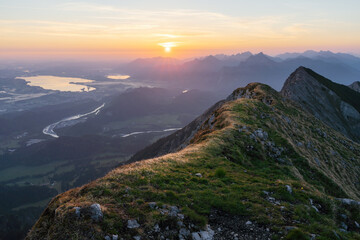 Fototapeta na wymiar Sunrise on top of mountain große Schlicke with valley view of Füssen and Schwangau