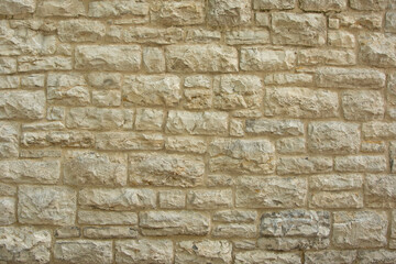 Fototapeta premium Yellow vintage stone brick wall texture. Basis background