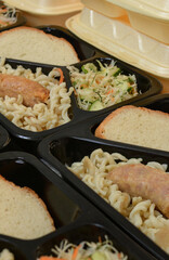 Lunch boxes (salad, chicken leg, pasta). Free lunches for needy and internally displaced persons. Lunch delivery concept. Online orders