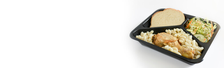 Box with lunch (salad, chicken leg, pasta,bread) on a white background. Free lunches for the needy and IDPs. Lunch delivery concept. Online orders.Banner. Copy space