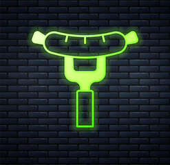 Glowing neon Sausage on the fork icon isolated on brick wall background. Grilled sausage and aroma sign. Vector