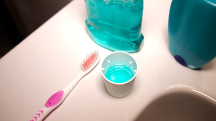 fluoride cap and toothbrush in the bathroom - obrazy, fototapety, plakaty
