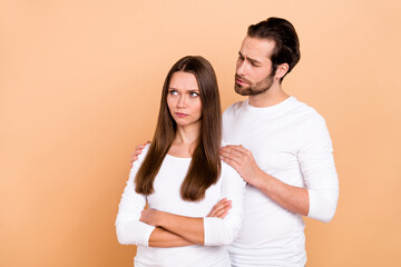 Photo of sad millennial brown hairdo couple crossed arms wear outfit isolated on beige color background