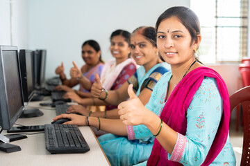 group of smiling women showing thumbs up by looking camera during computer training class - concept of women employment, learning and education - obrazy, fototapety, plakaty