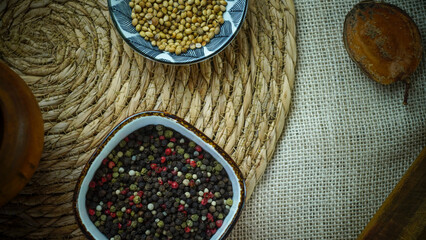 condiments and spices hot peppers saffron cloves and nuts. rustic farmhouse style mortar. ingredients for cooking.