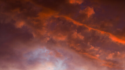 Fototapeta na wymiar Teintes orangées observées sous des nuages laiteux, de haute altitude