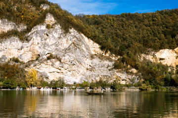 Fototapeta premium Magnificent lake in the mountains - old fishing boat on the tranquil surface of Drina river on the border between Serbia and Bosnia and Herzegovina