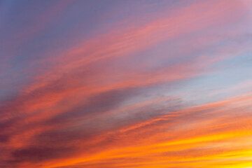 Naklejka na ściany i meble The setting sun in a colored sky.
