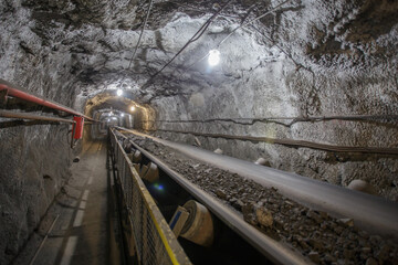 Underground belt conveyor for transporting ore to the surface.