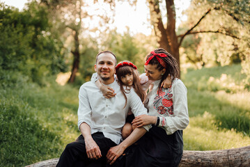 Ukrainian family in traditional embroidery clothes called vyshyvanka during outdoor walk