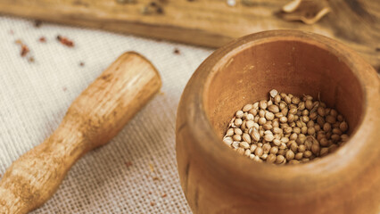 condiments and spices hot peppers saffron cloves and nuts. rustic farmhouse style mortar. ingredients for cooking.