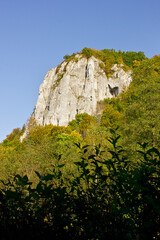 Autumn landscape. A rock in an autumn forest