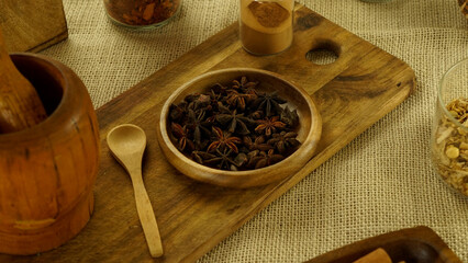 condiments and spices hot peppers saffron cloves and nuts. rustic farmhouse style mortar. ingredients for cooking.