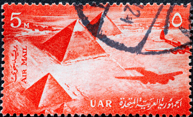 EGYPT - CIRCA 1959: a postage stamp from EGYPT , showing a historic Airplane & Pyramids at Giza....