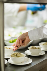 chef making salad in restaurant