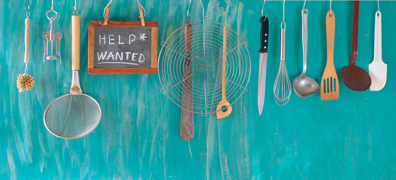 Help wanted sign,restaurant or cafe looking for staff after corona lockdown, kitchen utensils and job ad on blackboard, free copy space