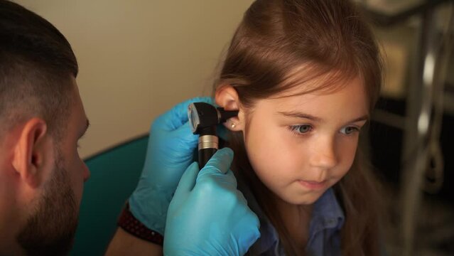 4k video otoscopy of child ears with otoscope. ENT doctor. Consultation with pediatric otolaryngologist. Treatment of childs ear pain.