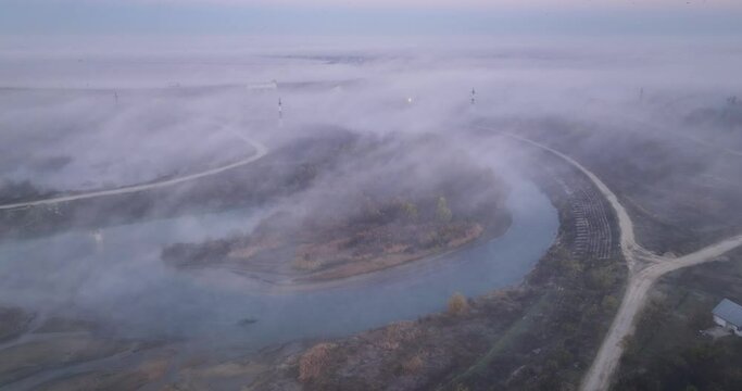Low light aerial drone shot of rased fog. and islands in foggy sunrise morning