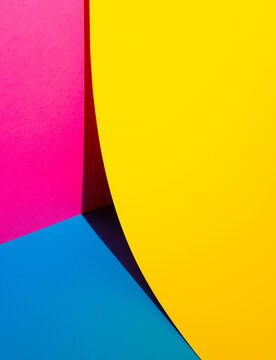 Vibrant bold colors paper 3d abstract background. Creative colorful copy space design. Yellow, blue and pink color composition. 