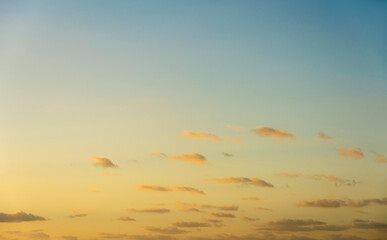 Blue sky with small calm clouds at sunrise