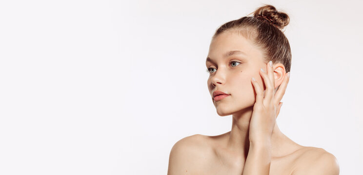 Portrait of young, beautiful and healthy girl with well-kept skin isolated on white background. The spa, surgery, face lifting and skin care concept