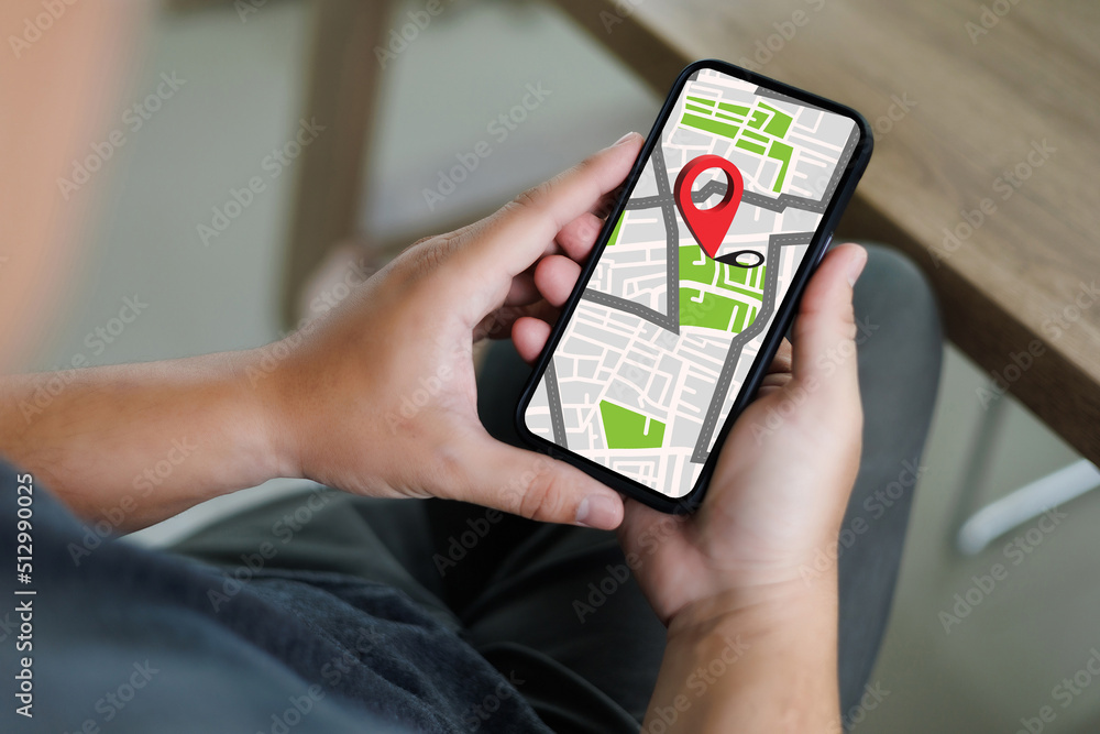 Poster hand using a smartphone holding gps map to route destination network connection location street map 
