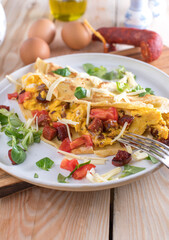 Breakfast burrito or pancake with scrambled egss, chorizo sausage, cheese, tomatoes and lettuce
