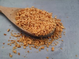 Garlic (allium) fried in a wooden spoon.