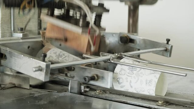 Cup Machine Loading. Coffee-to-go cup production on a machine.