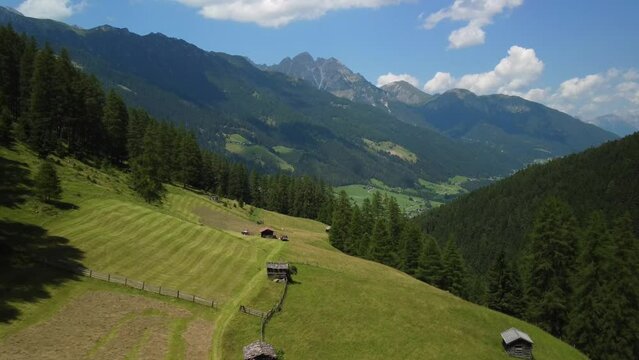 Cinematic aerial view from a drone flight over the meadows of Pinnis Valley, very close to Stubai Valley in Austria