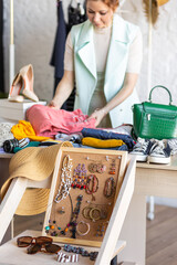 Young women at swap home party - clothes, shoes, bags, jewellery exchange between friends. Zero waste shopping, eco friendly concept, sustainable lifestyle. College life. 