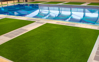 Green the artificial turf by the pool