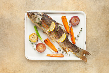 Fried carp whole. Served with lemon and roasted vegetables. Czech Traditional Christmas Food. Top view.