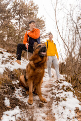 Taking a break with the dog in the forest while smiling and enjoying