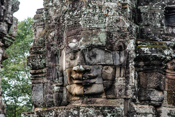 A large figure carved face on sandstone in the pagoda of Bayon Angkor Thom Temple, Siem Reap, Cambodia.
