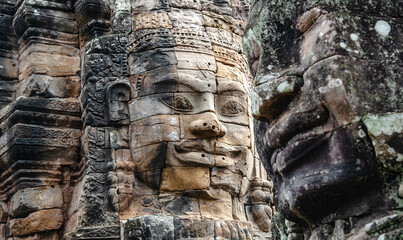 Fototapeta premium A large figure carved face on sandstone in the pagoda of Bayon Angkor Thom Temple, Siem Reap, Cambodia.