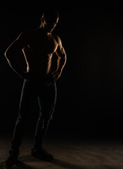 Male Posing topless in studio, silhouette