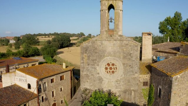 Aerial drone video footage of Spanish city Pubol. camera zooms on cathedral in the centerspain. small town located in the municipality of La Pera province of Girona, Catalonia. Top view from above