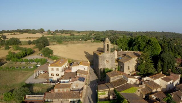 Aerial drone video footage of Spanish city Pubol. camera zooms in on the cathedral in the center. small town located in the municipality of La Pera province of Girona, Catalonia. Top view from above