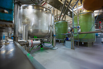 Stainless vertical steel tanks and pipes with pressure meter in equipment tank chemical cellar at the with stainless steel tanks